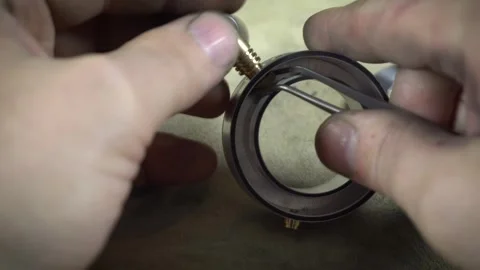 Assembling a precision ball bearing into a metal part Stockbeeldmateriaal 317137878
