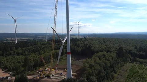 Assembling propeller blades and wind turbines on the background. Aerial view. Stock-Footage 73123712
