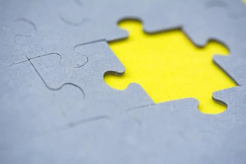Assembling the puzzle. Missing part of the jigsaw on yellow background. Home  Stock Photos