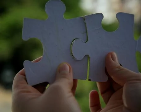 Assembling puzzle pieces Stock Photos