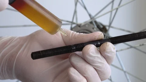 Assembling the rear hub of the bicycle wheel. Close-up shot Male hands in rubber Stock Footage 117533204