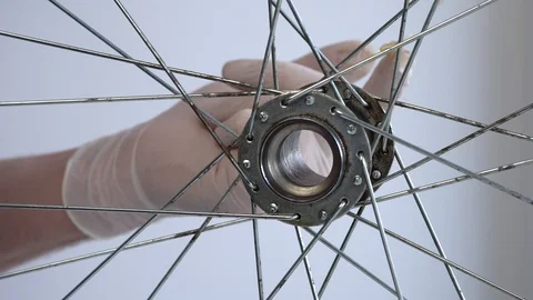Assembling the rear hub of the bicycle wheel. Close-up shot A male hand in a Stock Footage 117533222