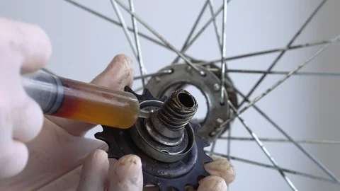 Assembling the rear hub of the bicycle wheel. Close-up shot A male hand in a Stock Footage 117533571