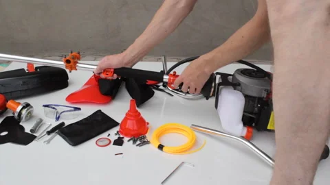 Assembling the shaft of a petrol brushcutter. Video stock 329150618