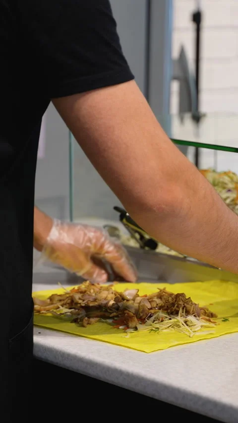 Assembling Shawarma Wraps with Meat and Sauce Stock Footage 311484990