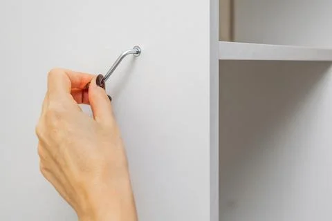 Assembling a shelving unit using an L-shaped Allen key. Photos