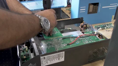 Assembling solar power inverter at renewable energy manufacturing Stock Footage 168869778