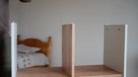 Assembling a Stylish and Modern Wooden Shelf Unit for Your Home or Office Space Stock Footage 308664180