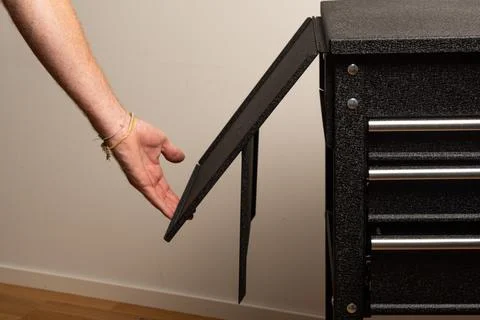 Assembling tool chest with panels and screws Stock Photos