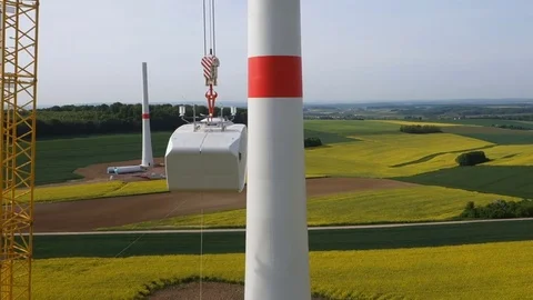 Assembling transmission towers for wind turbines with a crane. Aerial shot. Video stock 73123265