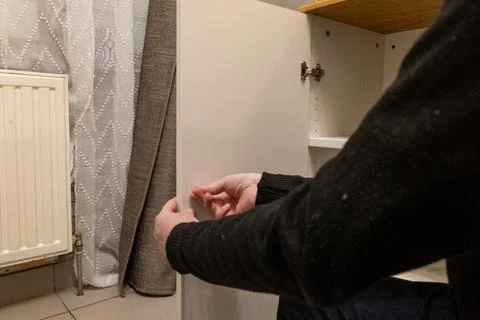 Assembling a white flatpack closet Stock Photos