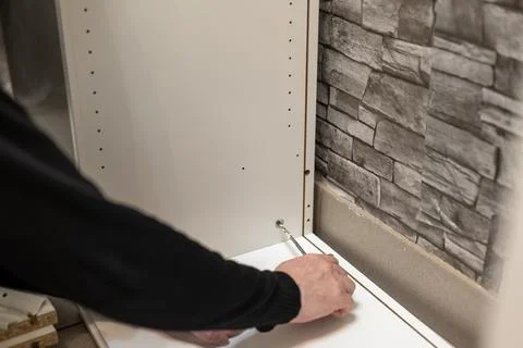 Assembling a white flatpack closet Stock Photos