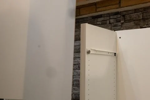 Assembling a white flatpack closet Stock Photos