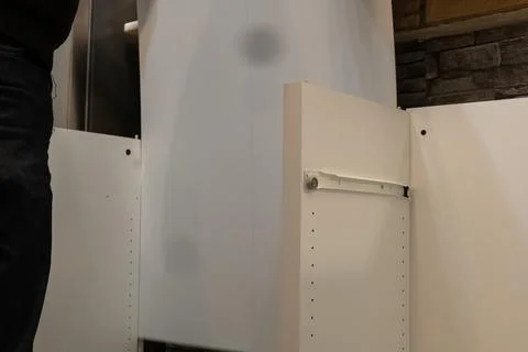 Assembling a white flatpack closet Stock Photos