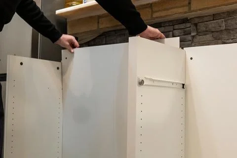 Assembling a white flatpack closet Stock Photos