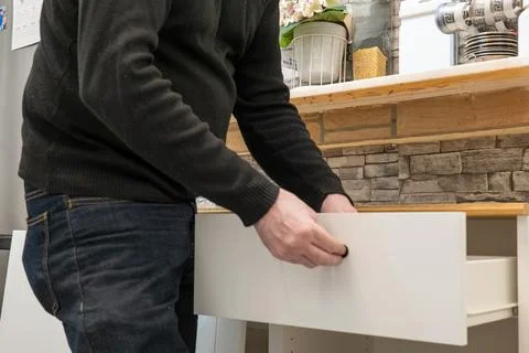 Assembling a white flatpack closet Stock Photos