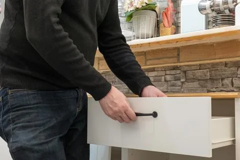 Assembling a white flatpack closet Stock Photos