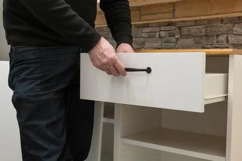 Assembling a white flatpack closet Stock Photos