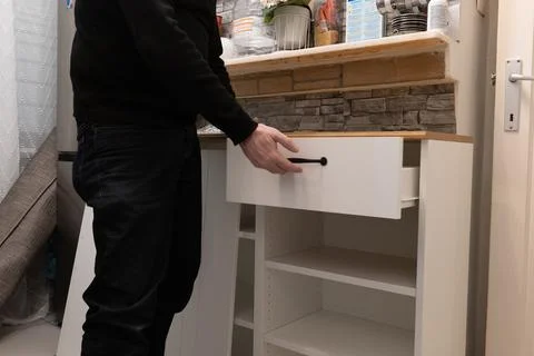 Assembling a white flatpack closet Stock Photos