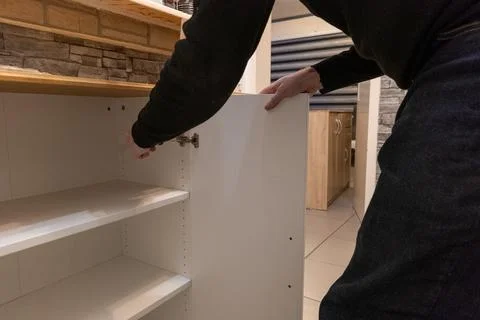 Assembling a white flatpack closet Stock Photos