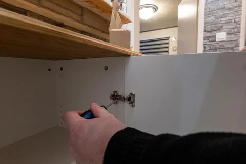 Assembling a white flatpack closet Stock Photos