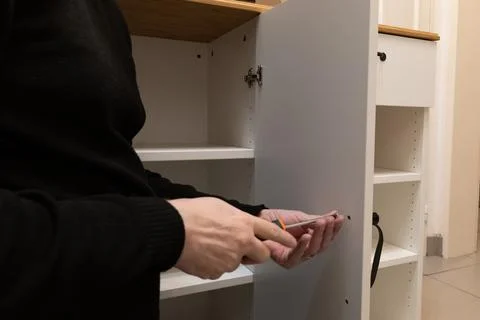 Assembling a white flatpack closet Stock Photos