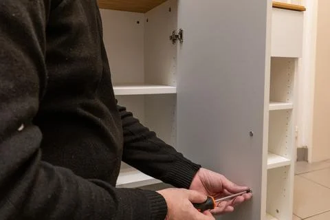 Assembling a white flatpack closet Stock Photos