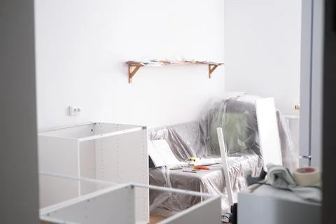 Assembling the white frames of the modular kitchen. Step by step assembly Stock Photos