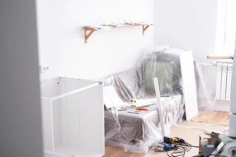 Assembling the white frames of the modular kitchen. Step by step assembly Stock Photos