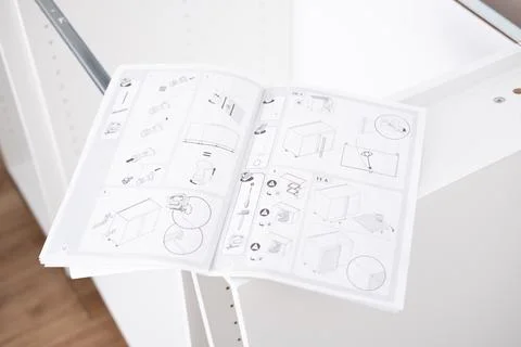 Assembling the white frames of the modular kitchen. Step by step assembly Stock Photos