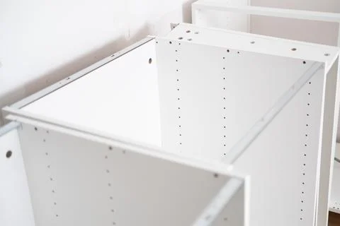 Assembling the white frames of the modular kitchen. Step by step assembly Stock Photos