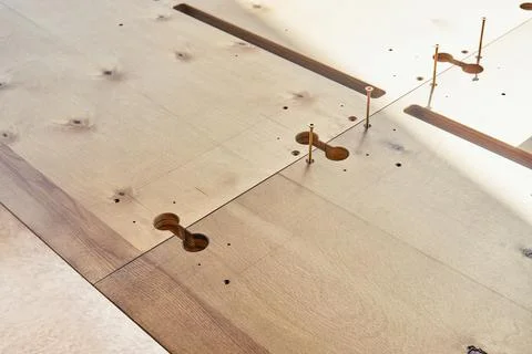 Assembling of wooden dining table with worktop connectors Stock Photos