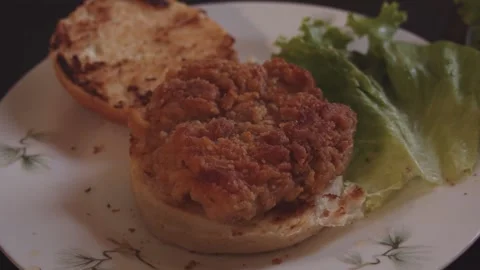 Assembling zinger burger with cheese Stock Footage 132829342