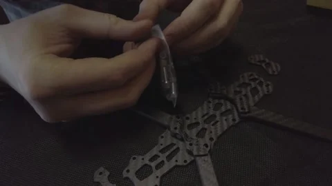 Assembly of carbon frame for FPV quadcopter, 5 inches Stock Footage 168341629