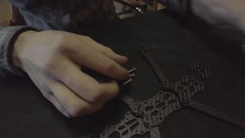 Assembly of carbon frame for FPV quadcopter, 5 inches Stock Footage 168341762