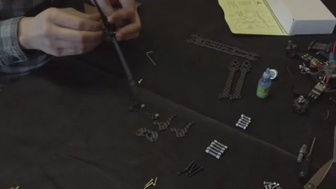 Assembly of carbon frame for FPV quadcopter, 5 inches Stock Footage 168342458