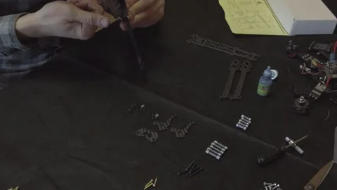 Assembly of carbon frame for FPV quadcopter, 5 inches Stock Footage 168342680