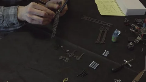 Assembly of carbon frame for FPV quadcopter, 5 inches Stock Footage 168342724