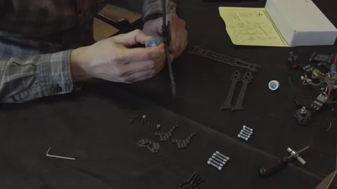 Assembly of carbon frame for FPV quadcopter, 5 inches Stock Footage 168342925