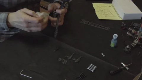 Assembly of carbon frame for FPV quadcopter, 5 inches Stock Footage 168344456