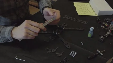 Assembly of carbon frame for FPV quadcopter, 5 inches Stock Footage 168344641