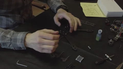 Assembly of carbon frame for FPV quadcopter, 5 inches Stock Footage 168344812