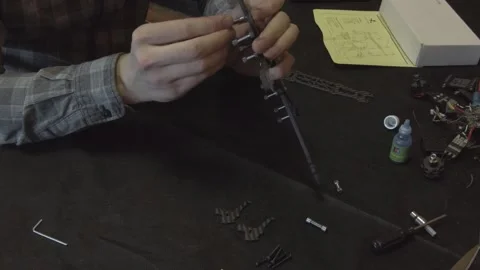 Assembly of carbon frame for FPV quadcopter, 5 inches Stock Footage 168345511