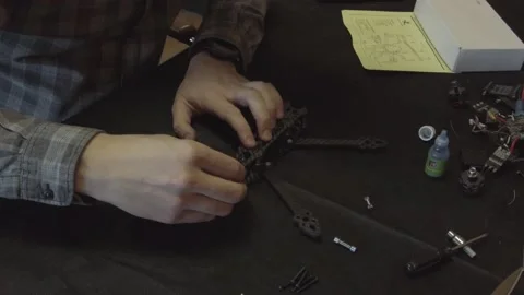 Assembly of carbon frame for FPV quadcopter, 5 inches Stock Footage 168346043