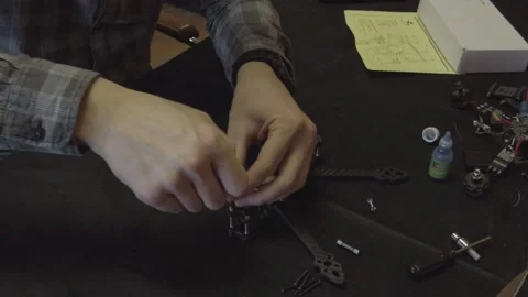 Assembly of carbon frame for FPV quadcopter, 5 inches Stock Footage 168346132
