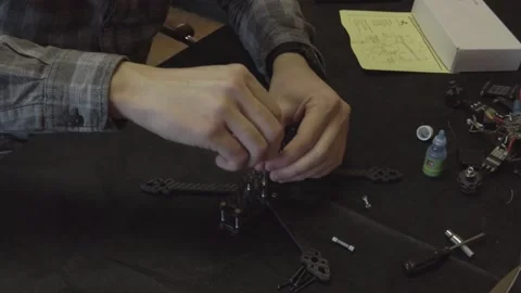 Assembly of carbon frame for FPV quadcopter, 5 inches Stock Footage 168346151