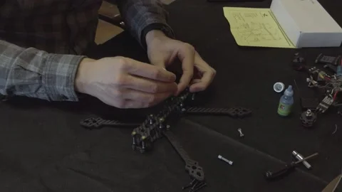 Assembly of carbon frame for FPV quadcopter, 5 inches Stock Footage 168347938