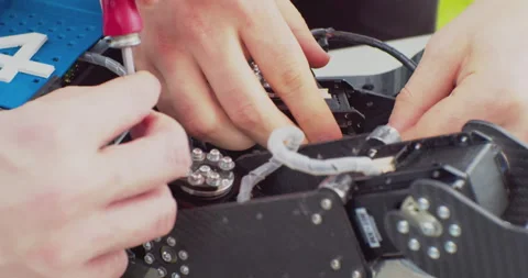 Assembly of a complex mechanism with a screwdriver.close-up Stock Footage 163155235