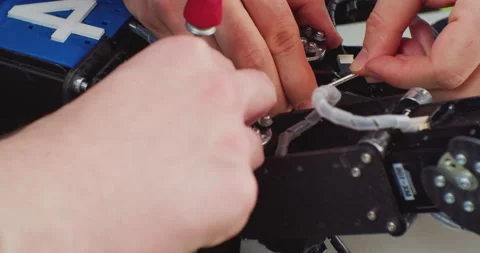 Assembly of a complex mechanism with a screwdriver.hands of a working man close Stock Footage 163155767