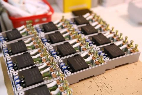 Assembly of electronic components for voltage relays. Manual assembly of elec Stock Photos